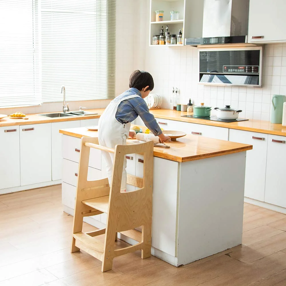 An EGREE kitchen step stool in natural wood at a kitchen island